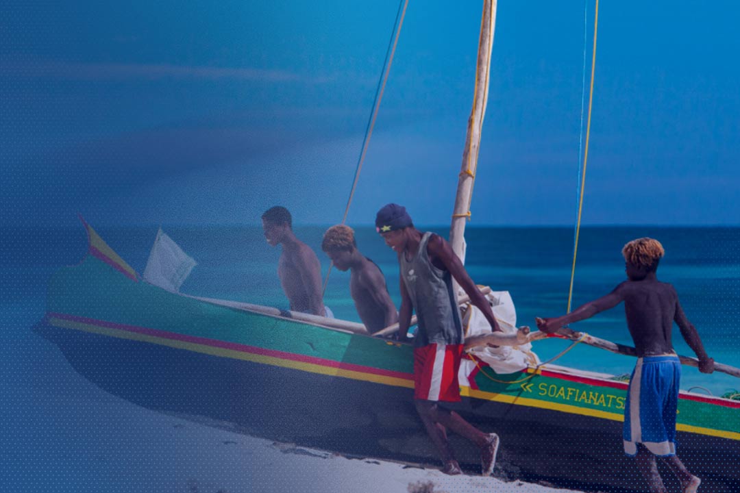 test Fishermen in Madagascar pull their boat ashore