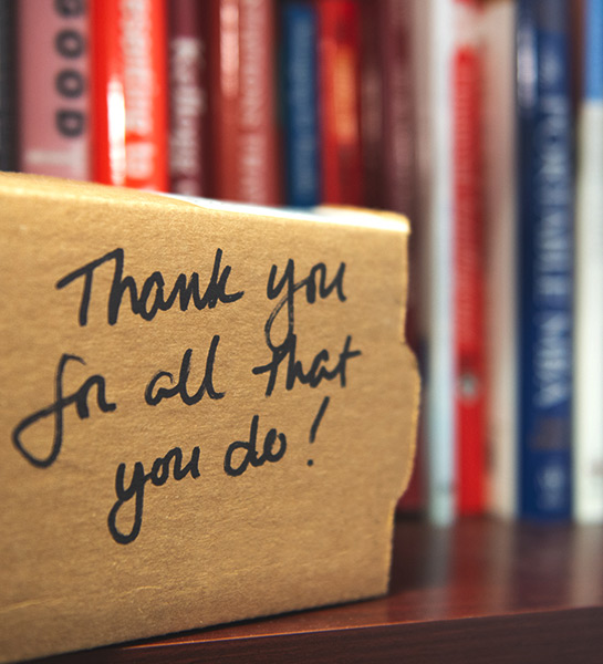 A cardboard box with thank you for all that you do written on it