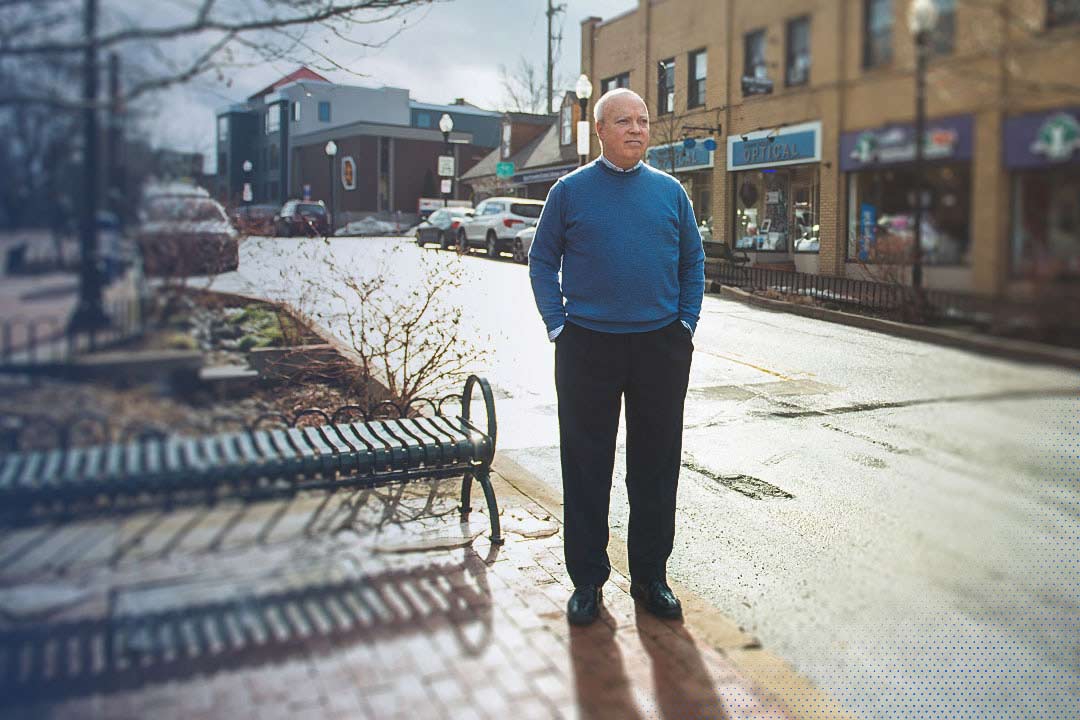 test Tom Sharbaugh standing on a sidewalk in downtown State College, PA