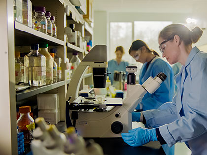 Penn State graduate students examine samples with microscopes