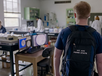 A Penn State Greater Allegheny student wearing a Penn State backpack