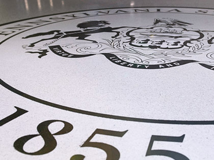 A photo of the Penn State seal on the floor of the HUB-Robeson Center