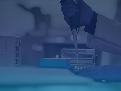A photo of a Penn State researcher using a pipette