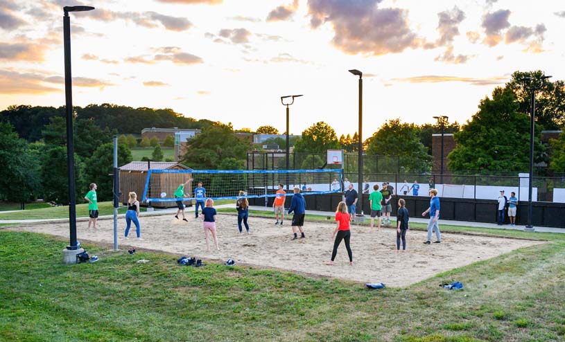 Penn State Beaver students playing sand volleyball court outside of Harmony Hall.