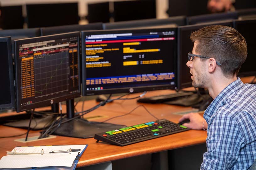 A male student using a Bloomberg Terminal