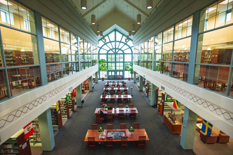The interior of Lilley Library showing stacks of books and tables for individual study