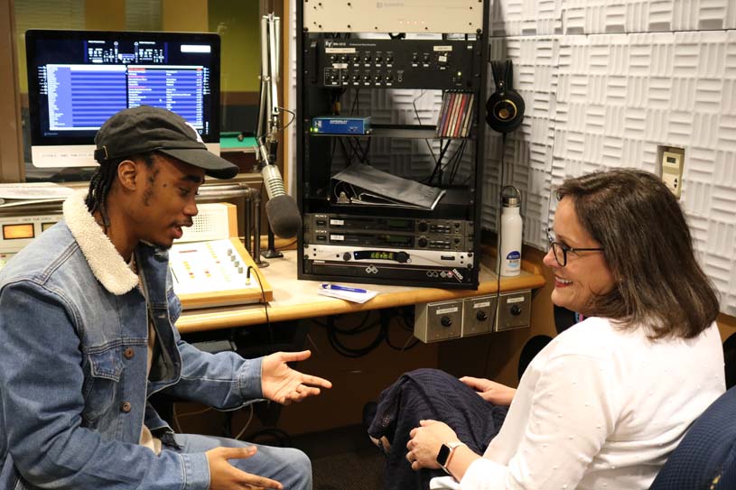 A Penn State Greater Allegheny student and the Chancellor seated in the campus radio station preparing for a live interview.