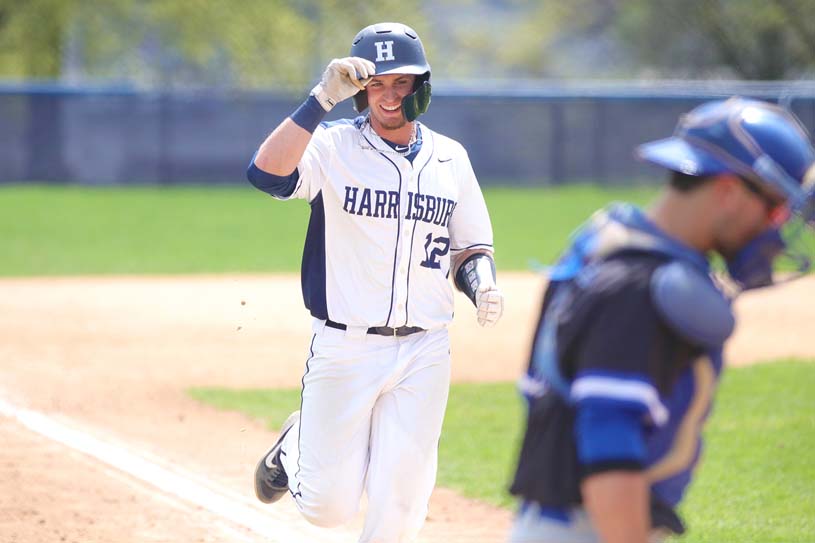 A Penn State Harrisburg men’s baseball team player runs to home plate.