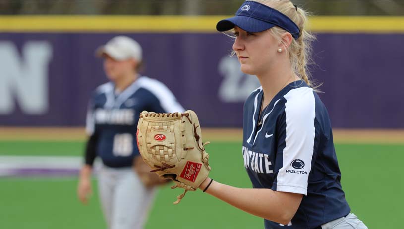 Penn State Hazleton’s women’s softball player on the mound about to deliver a pitch with a teammate in the background.