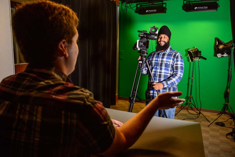 Lehigh Valley student operating a video camera in a studio.