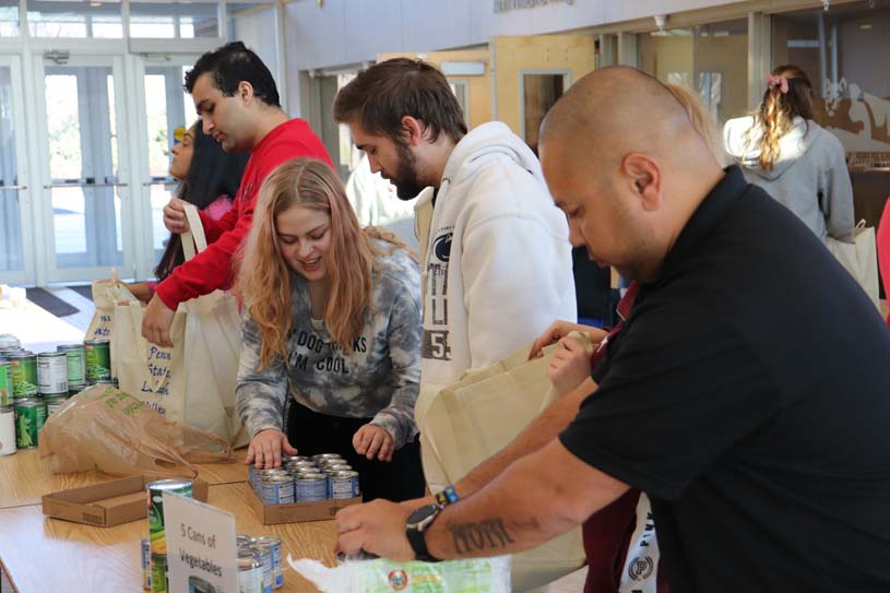 Lehigh Valley students packing bags of canned goods for Thanksgiving food drive donations.