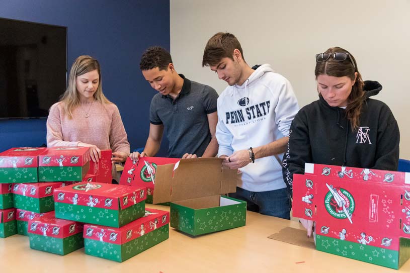 Four York students put together shoeboxes for a community service project.