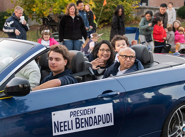 Neeli Bendapudi rides in a convertible with her husband and young grandchild as part of a homecoming parade.