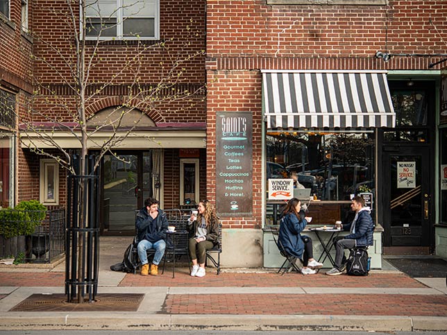 People sitting outside a downtown coffeeshop