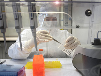 Suited researcher working in laboratory