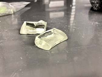 Two small samples of LionGlass on a table