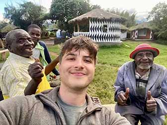 Brandon George taking a selfie with 3 village men in a Rwandan village