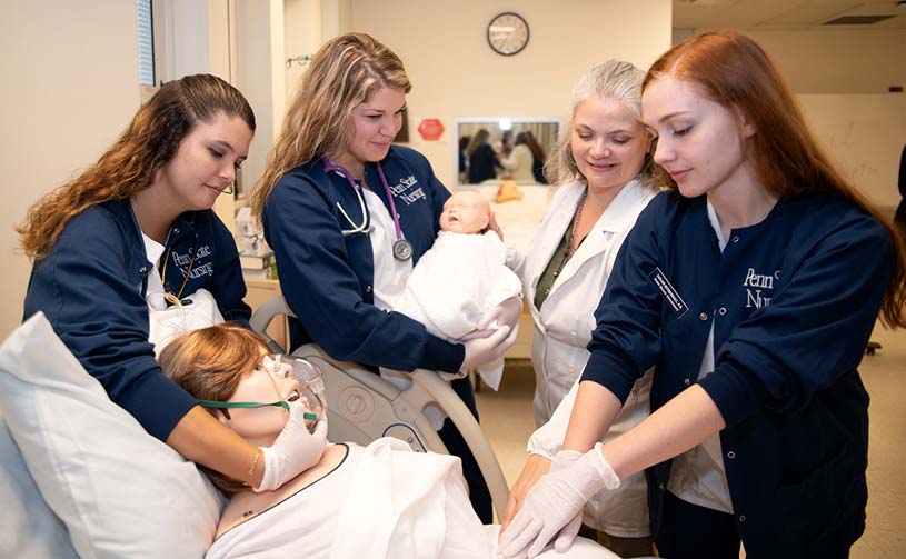 Fayette nursing students and professor work with a simulated patient and infant.