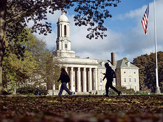 Old Main with students walking past