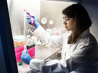 Researcher filling vial