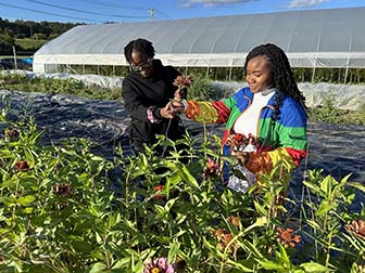 Two students picking flowers
